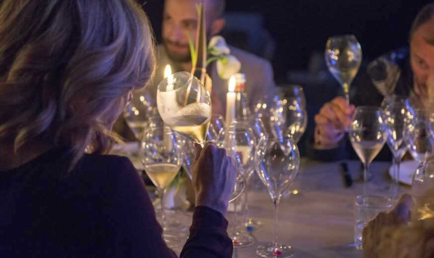 Ospiti brindano con calici di vino durante una cena di The Night Dinner di Vinòforum della scorsa edizione